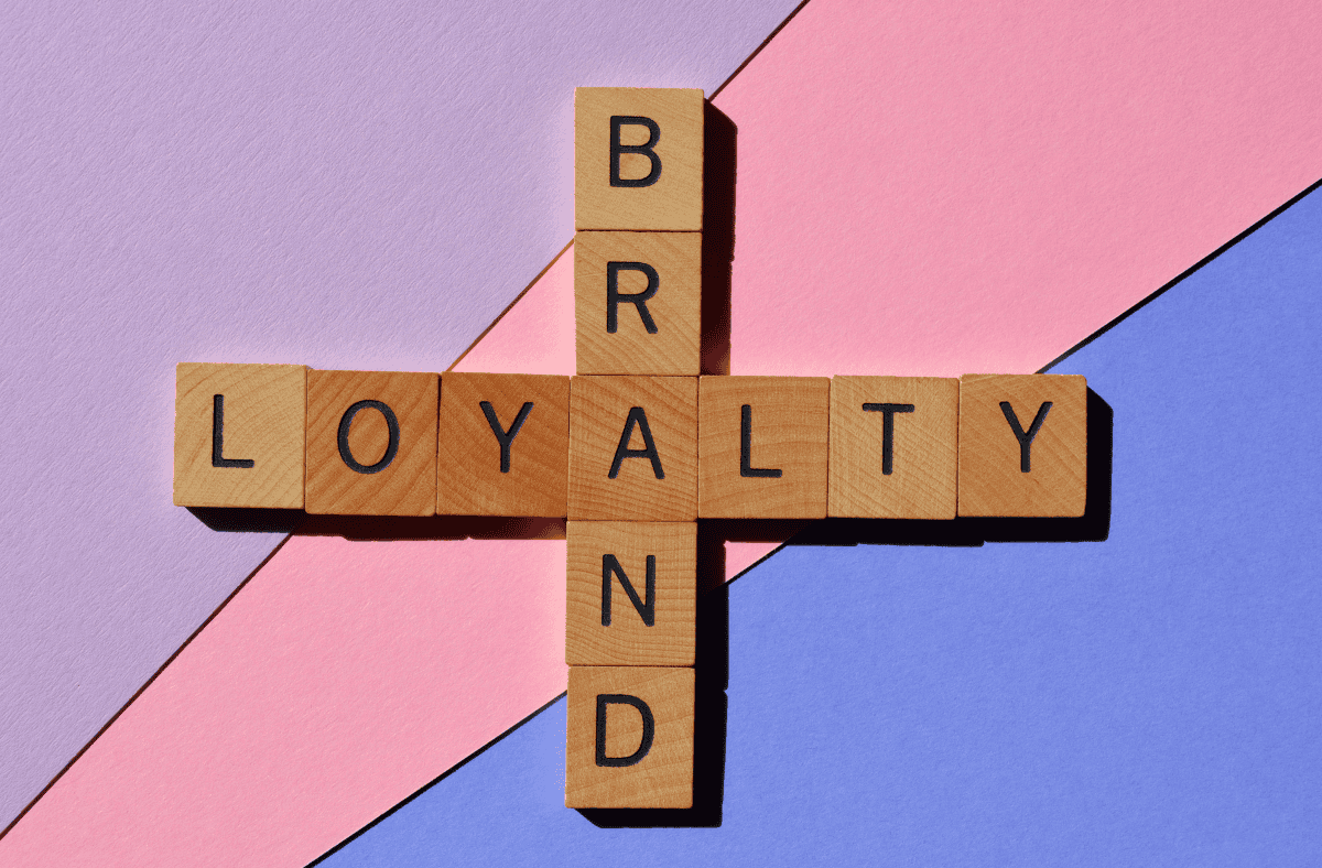 Wooden blocks spelling brand loyalty, representing how loyalty points and rewards are built through long term engagement rather than single purchases